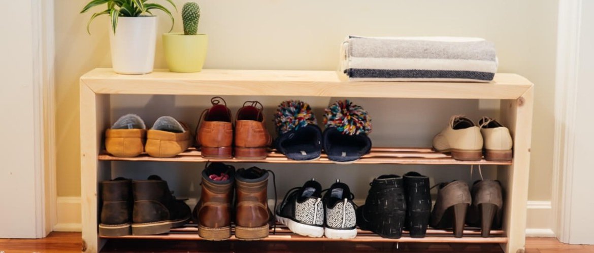 A shoe rack in the foyer